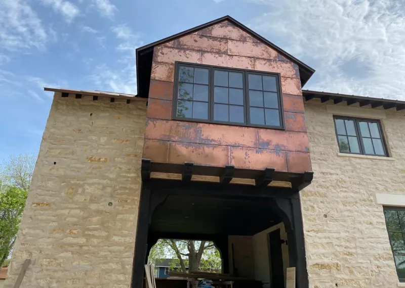 Copper metal panel facade on a stone building for Skylight Installation in Rosenberg