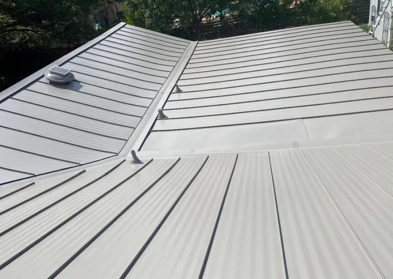 Solar attic fan installed on a metal roof for Roof Ventilation in Rosenberg